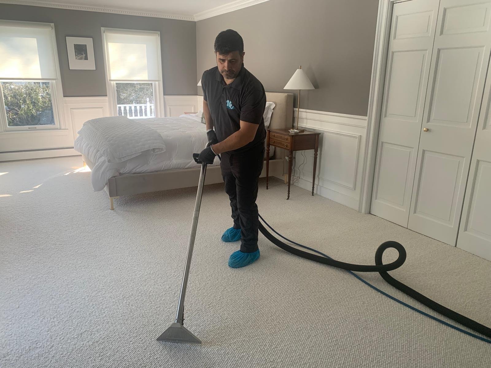 Alex steam-extracting a bedroom carpet in a Connecticut home