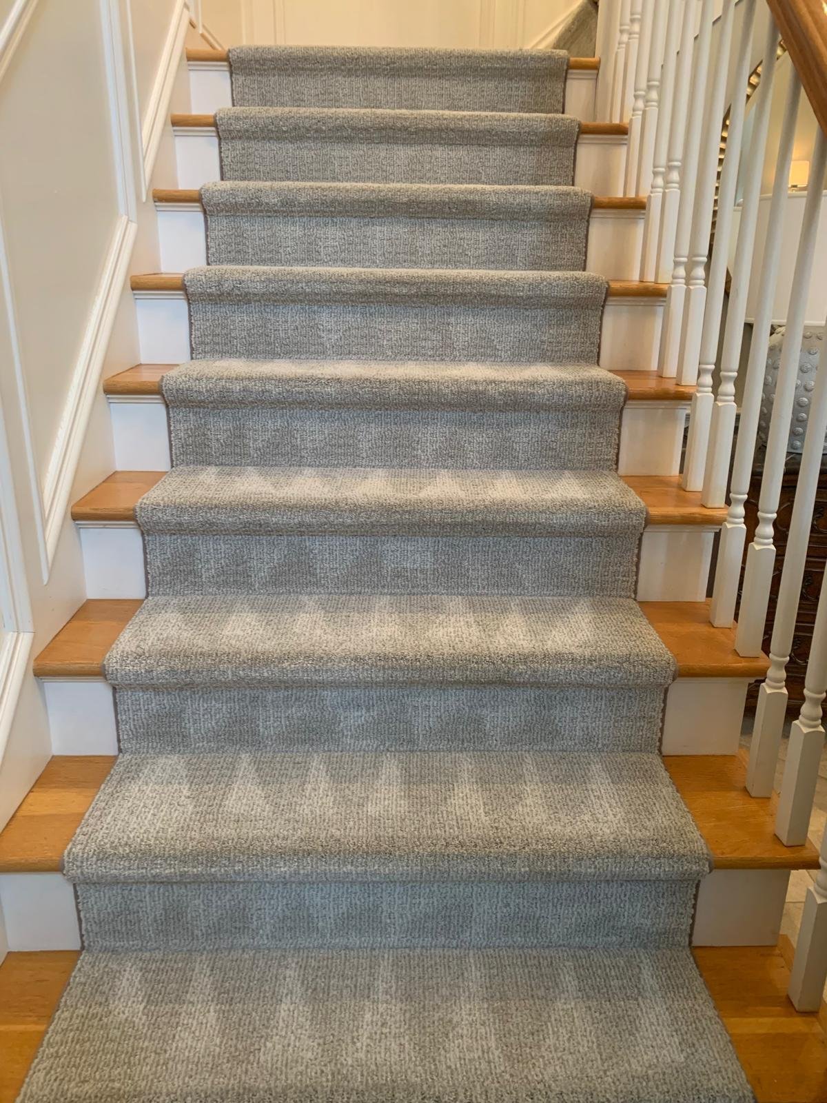 Freshly cleaned grey stair runner in a Connecticut home